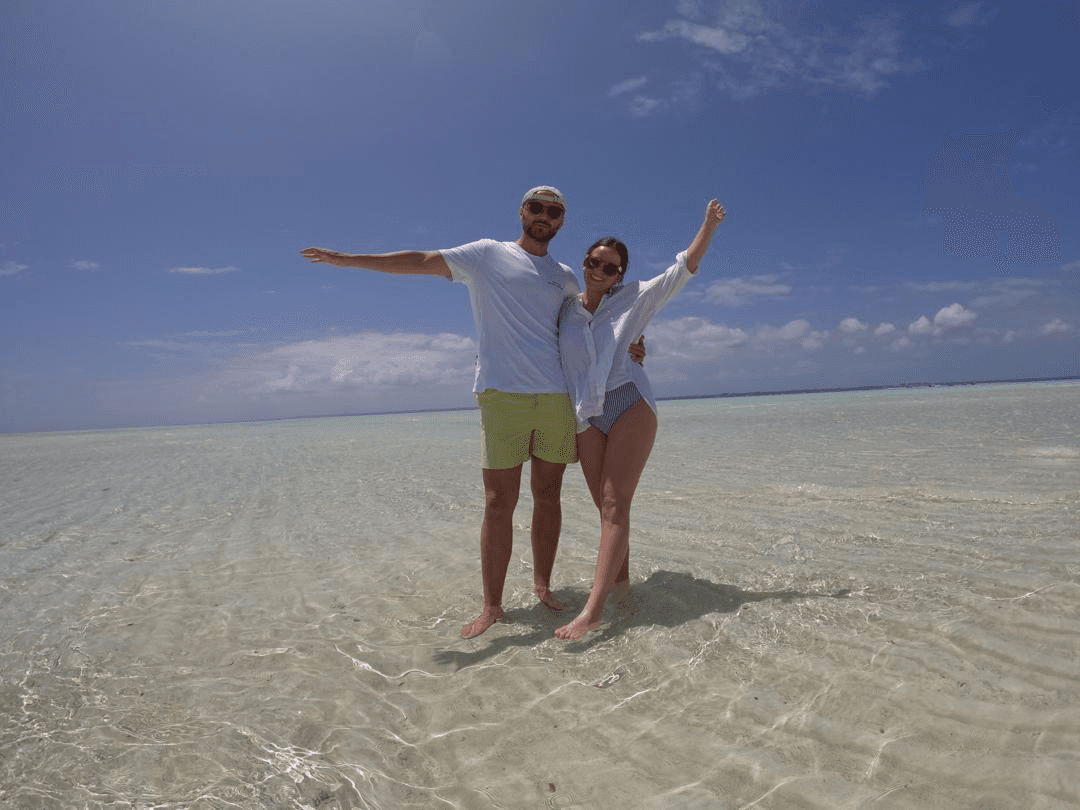 Guests standing in clear shallow water at Nakupenda Sandbank in Zanzibar