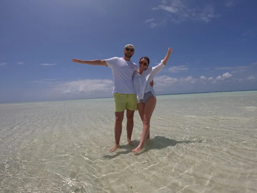 Guests standing in clear shallow water at Nakupenda Sandbank in Zanzibar