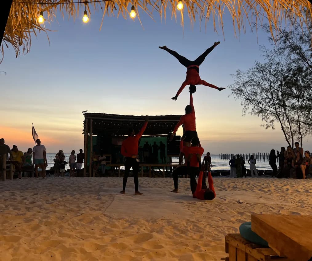 Beach sunset with performers and warm lights in Zanzibar
